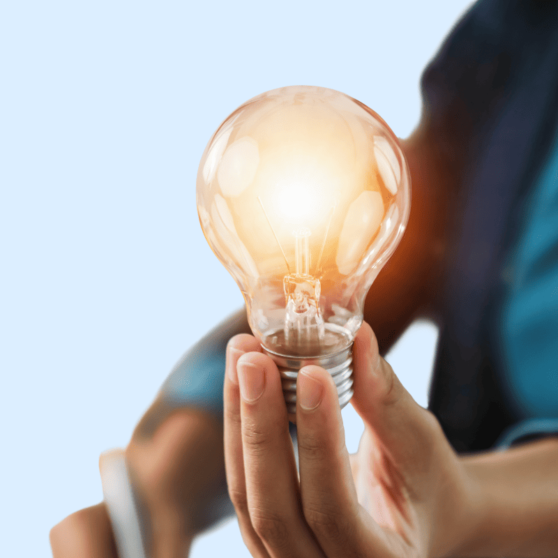 Een gloeilamp in de hand symboliseert lichtopbrengst in lumen.